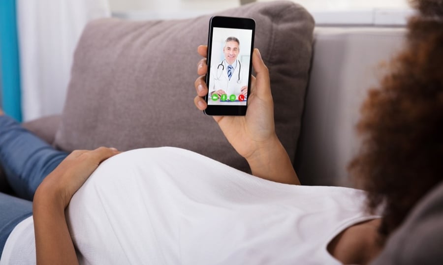 Pregnant-Woman-Video-Conferencing-With-Doctor-On-Smartphone-905726948_1258x839-1-1